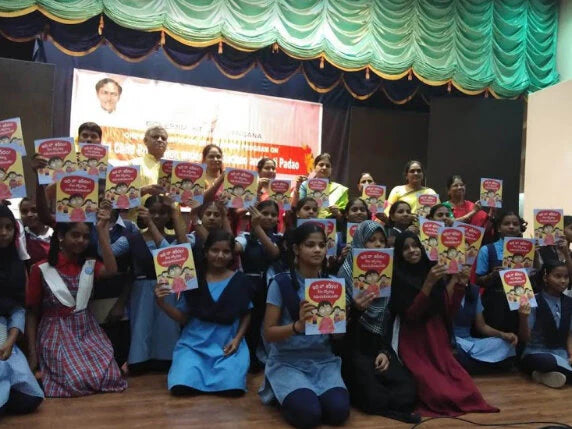 A group of children holding up Educate2Empowers collaborative book with World Vision India titled 'My Body! What I Say Goes!'